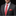 Man wearing a gray suit with a red tie and pocket square on a black background