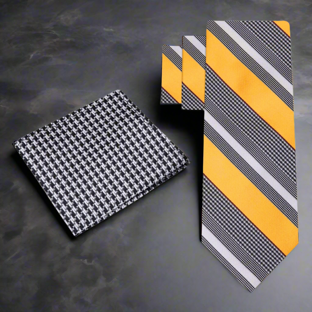 Set of patterned ties and pocket square on a grey  background