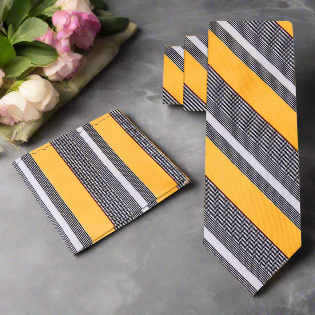 Set of yellow and gray striped ties on a grey background
