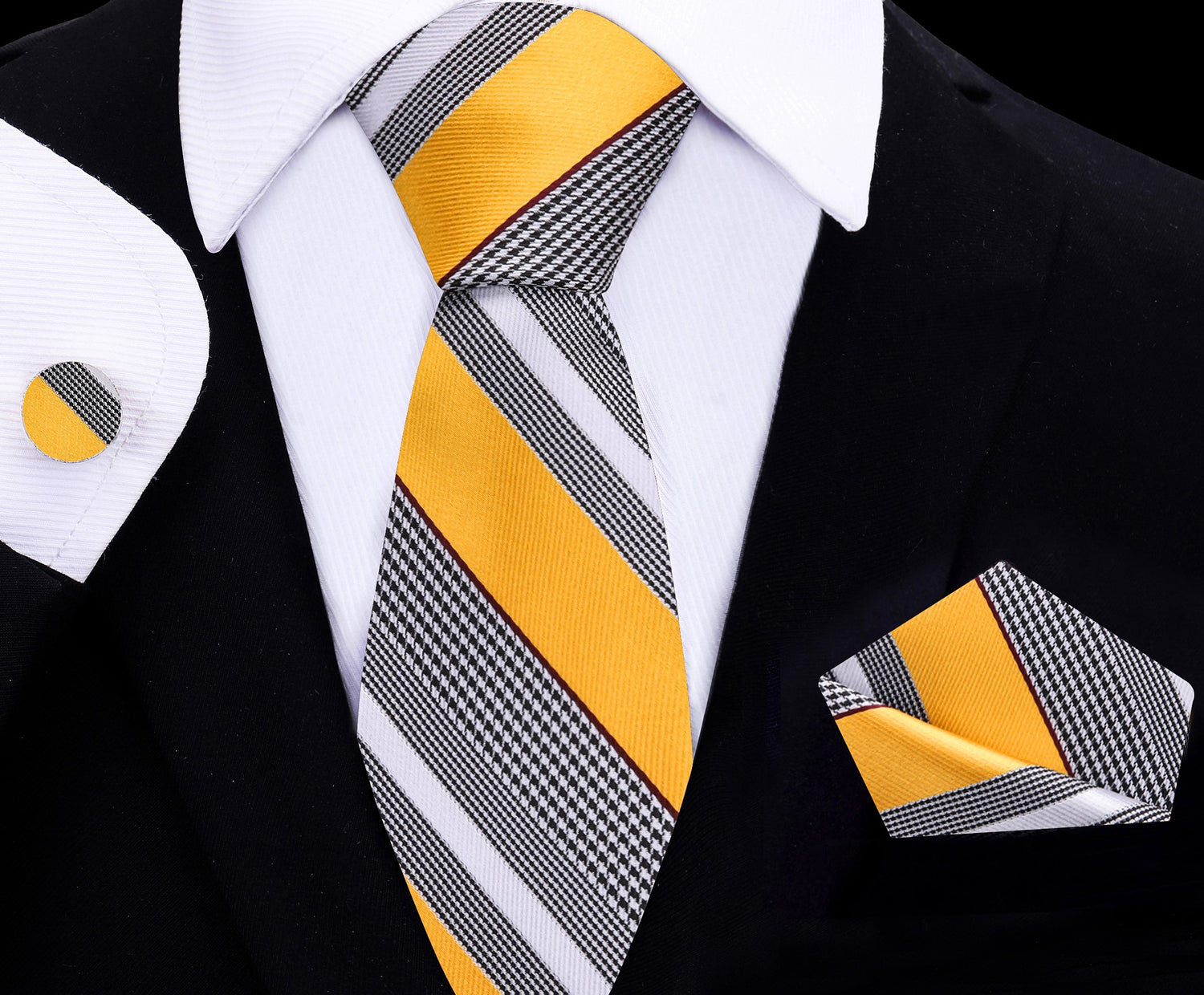 Yellow and gray striped tie with matching pocket square and cufflinks on a black suit.