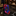 A rolled necktie with a bold abstract pattern in red, blue, black, and pink, displayed on a polished black marble surface in a luxury retail setting.