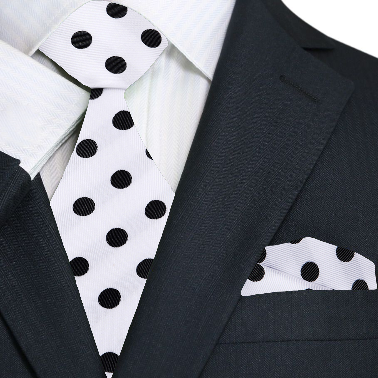 Black suit with white shirt, black and white polka dot tie, and matching pocket square.