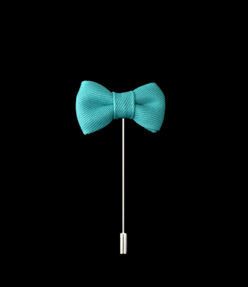 An Aqua Colored Bow Tie Shaped Lapel Pin||Aqua