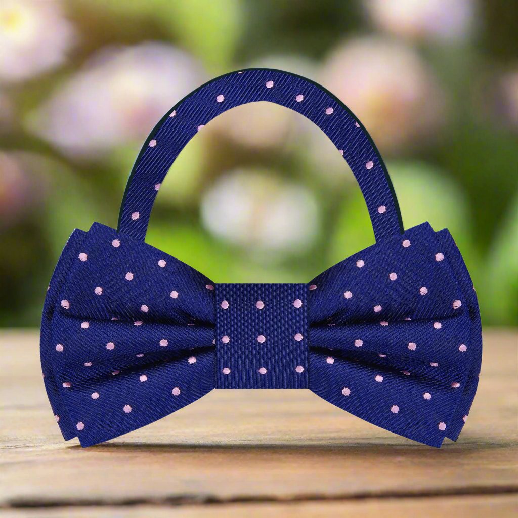 A blue and pink polka dot pre tied bow tie 