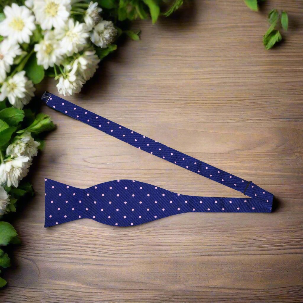 A blue and pink polka dot bow tie untied