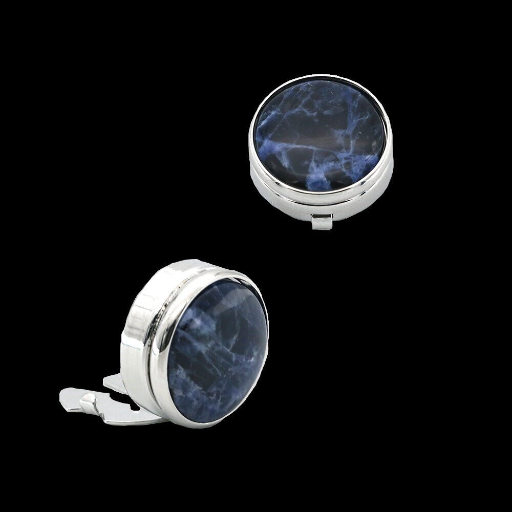 A Chrome colored button cover with blue black marble design