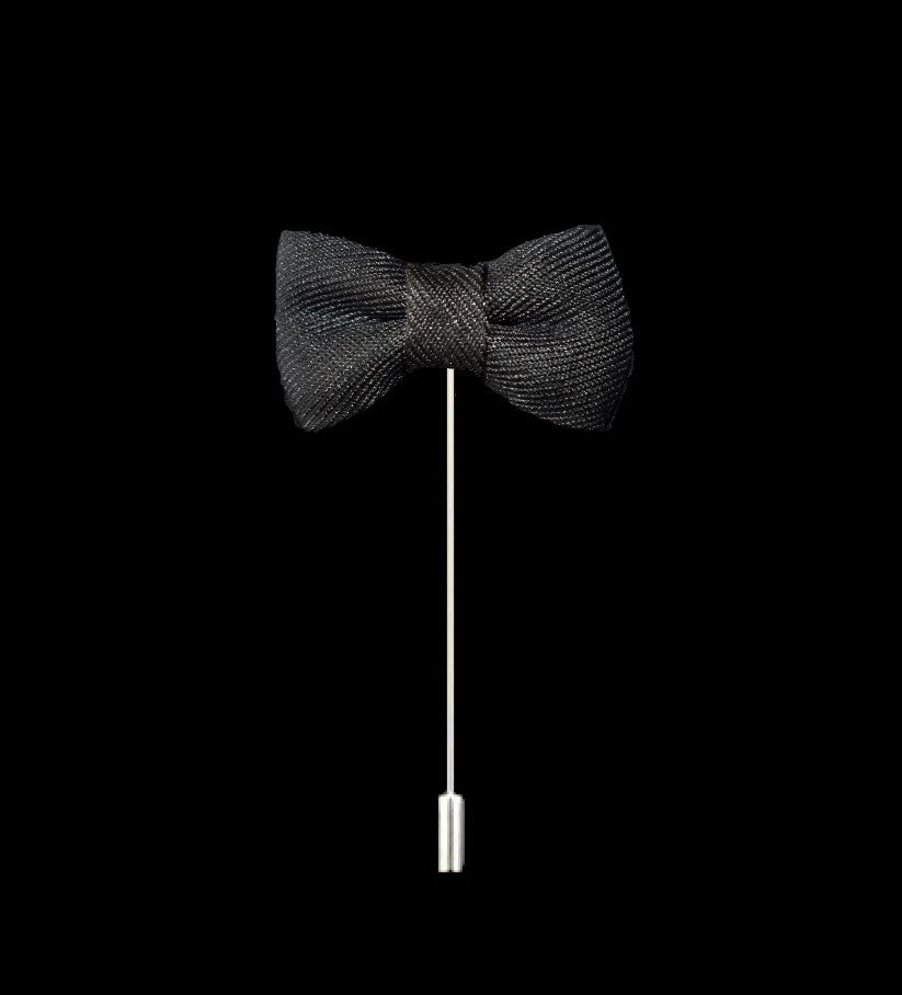 A Deep Charcoal Colored Bow Tie Shaped Lapel Pin||Deep Charcoal