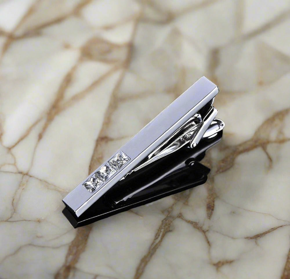 Tie bar View: A chrome colored tie bar and cuff-links with clear stones