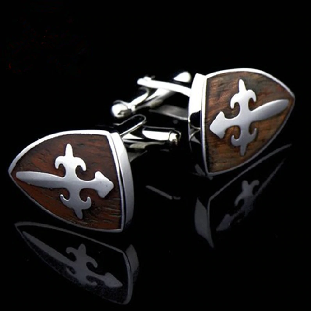 A Mahogany and Chrome Colored With Shield Shape and Cross Pattern Cuff-links