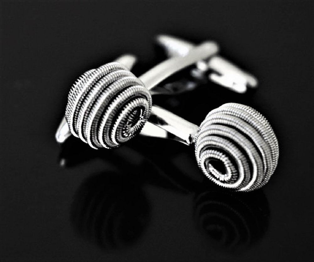 A silver sphere shaped cuff-links||Sphere