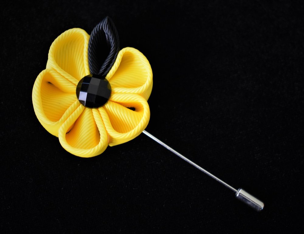 A Yellow, Black Colored Thick Petal Lapel Flower||Yellow, Black