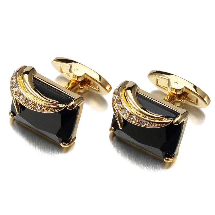 A Gold Colored with Black Gemstones Cuff-links.