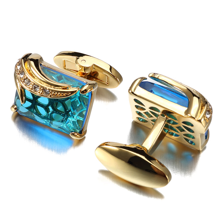 A Gold Colored with Clear and Light Blue Gemstones Cuff-links.