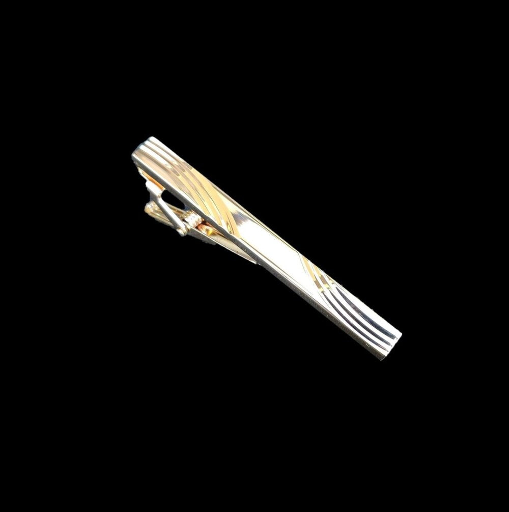 A Gold Colored with Waves Texture Tie Bar