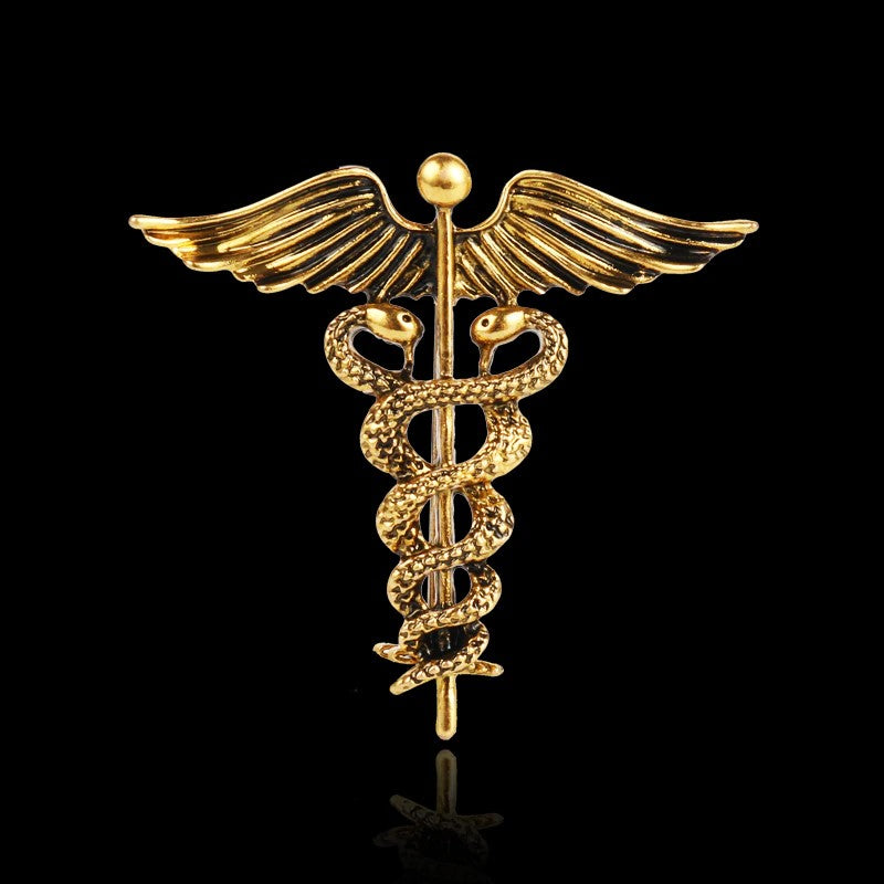 A Gold Colored Caduceus Shaped Lapel Pin