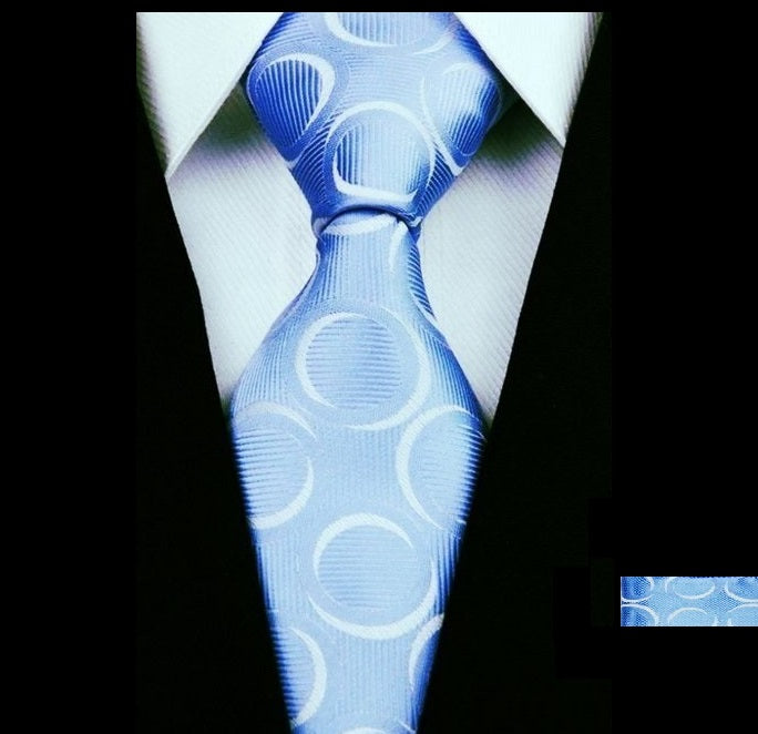 A Light Blue, White Rings Pattern Silk Necktie, Matching Pocket Square And Cuff-links
