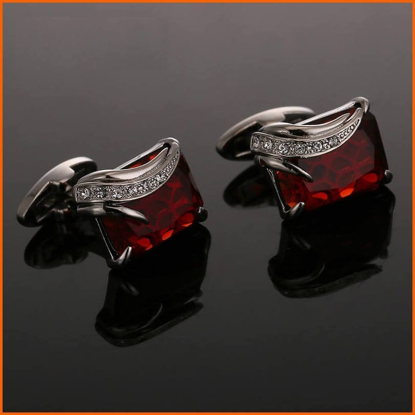 A Silver Colored with Clear and Red Gemstones Cuff-links.