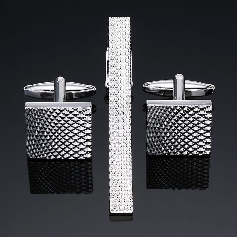 A silver textured tie bar and cuff-links||Silver