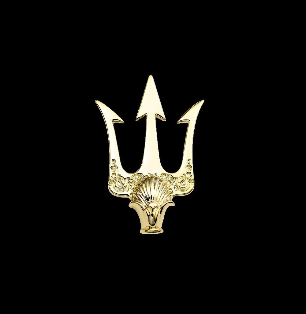 A Large Gold Colored Trident Shaped Lapel Pin