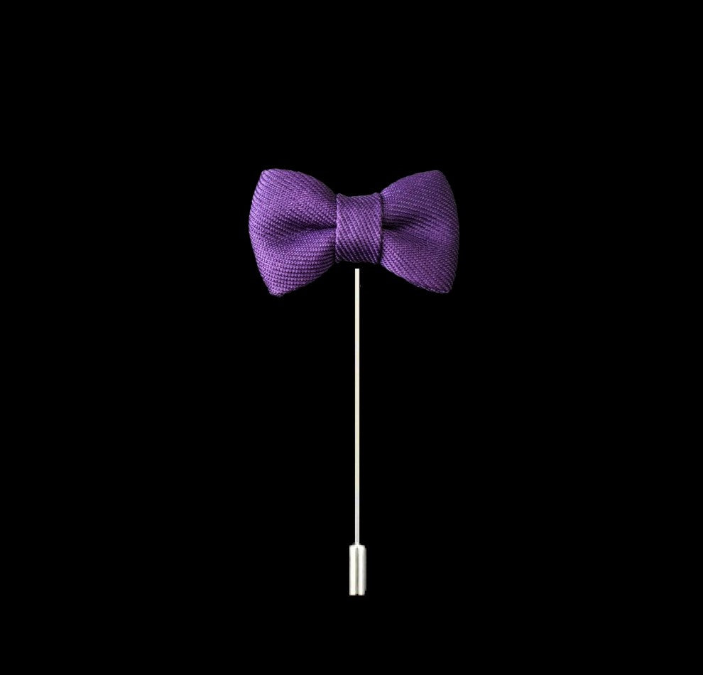 A Purple Colored Bow Tie Shaped Lapel Pin||Purple