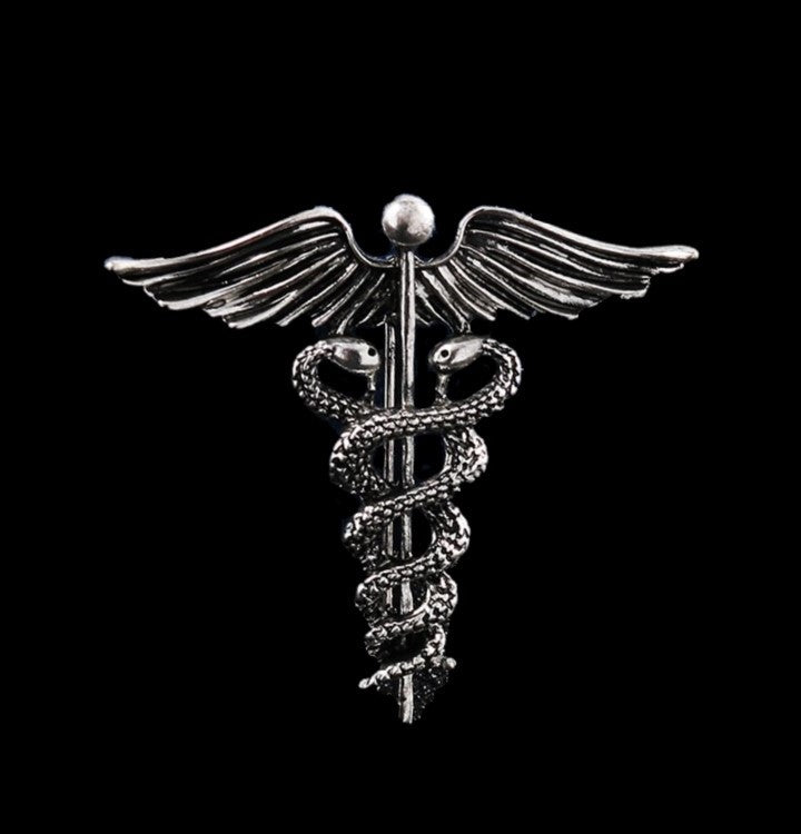 A Silver Colored Caduceus Shaped Lapel Pin