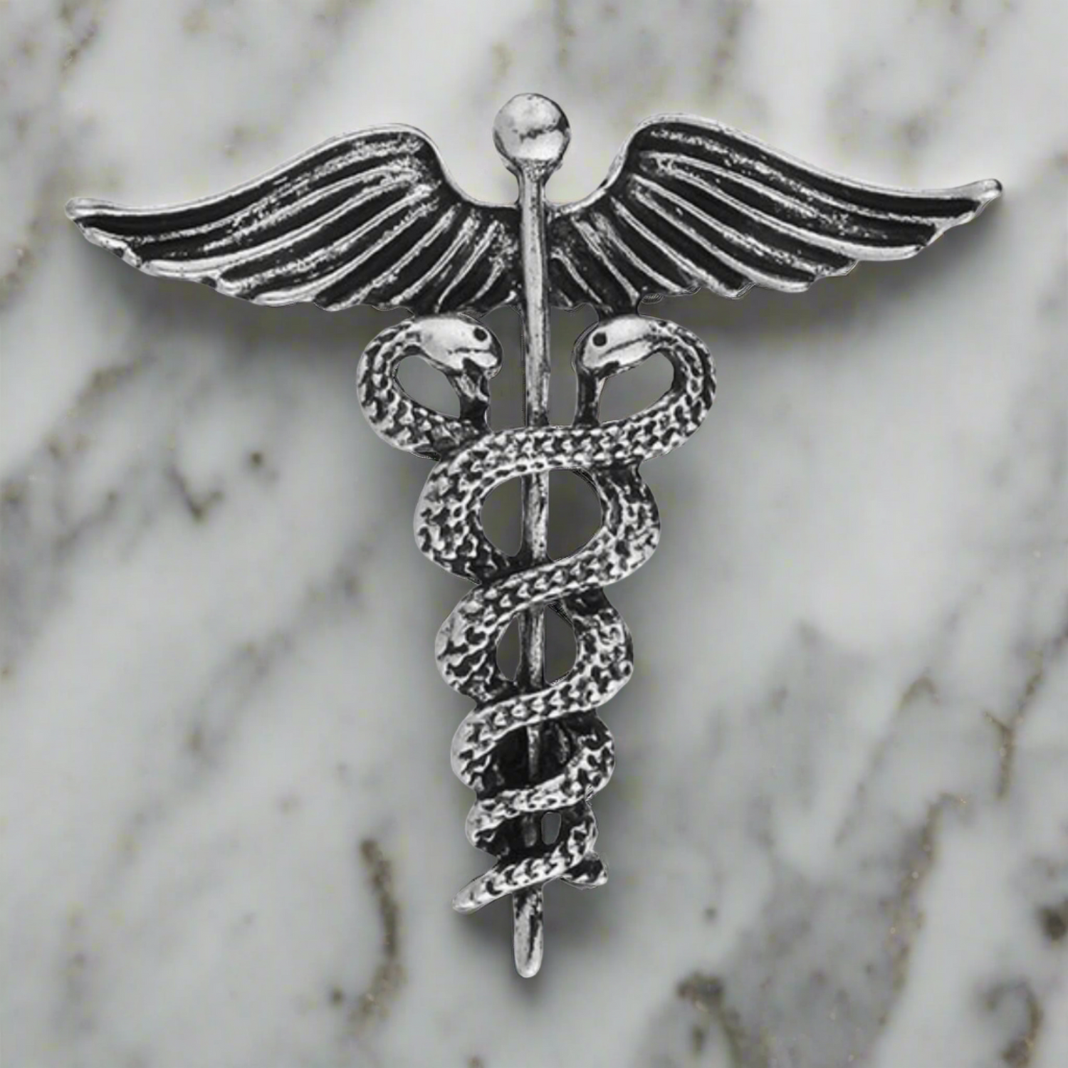 Main View: A Silver Colored Caduceus Shaped Lapel Pin