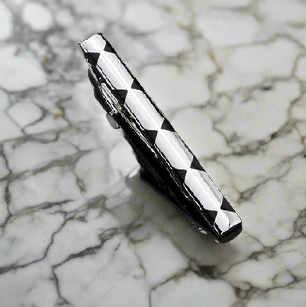 A Chrome and Black X Design Tie Bar