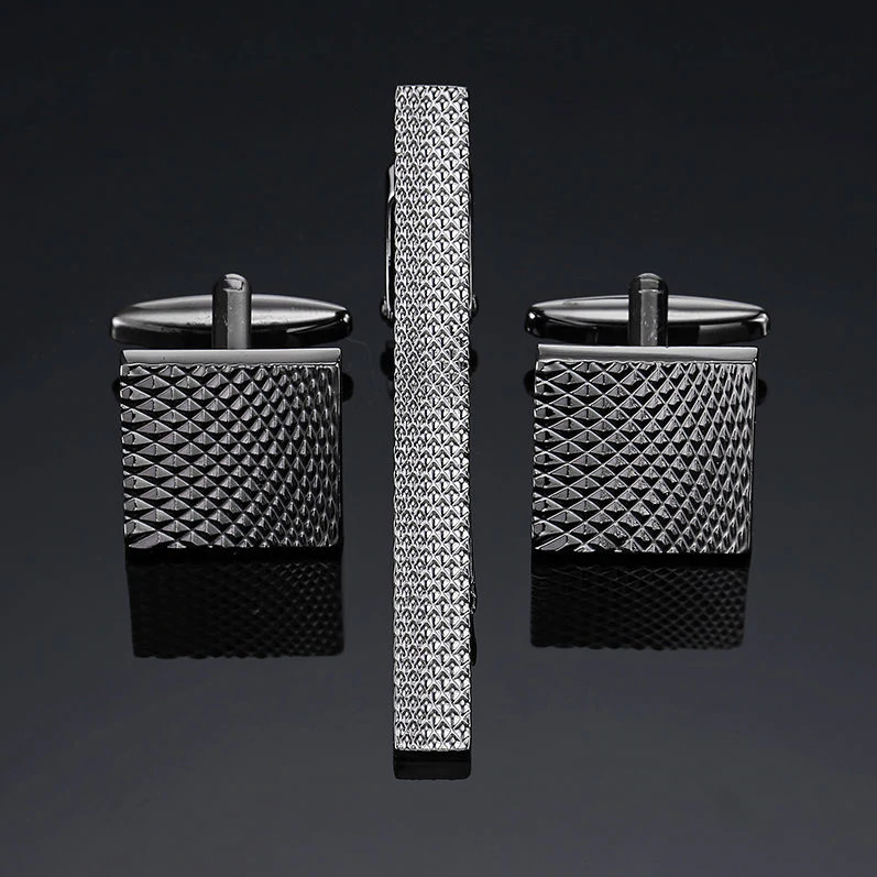 A charcoal textured tie bar and cuff-links||Charcoal