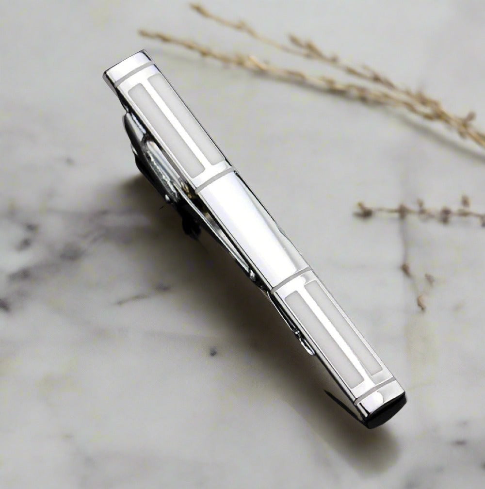 A Chrome, Pearl Lined Shaped Tie Bar