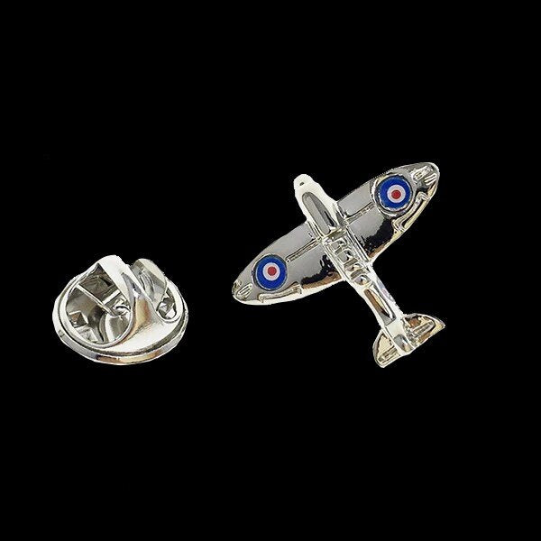A chrome colored airplane shaped lapel pin